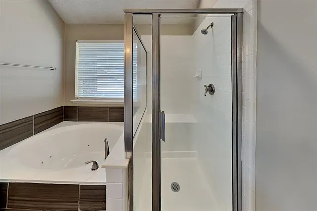 a bathroom with a bathtub and a shower