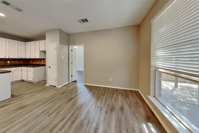 a view of a kitchen with a sink and wooden floor