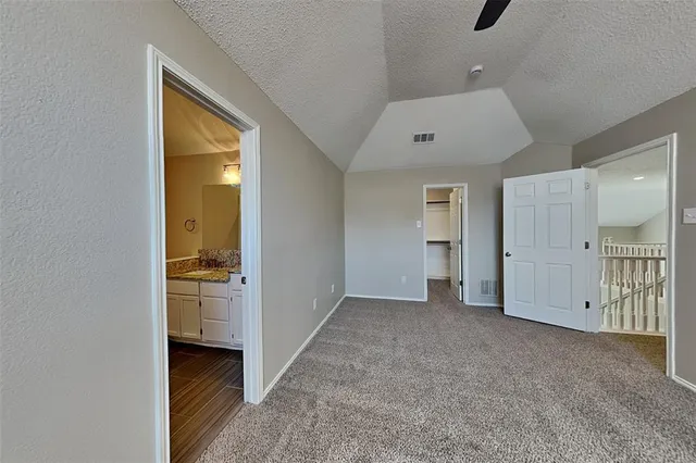 an empty room with a bathroom and a sink