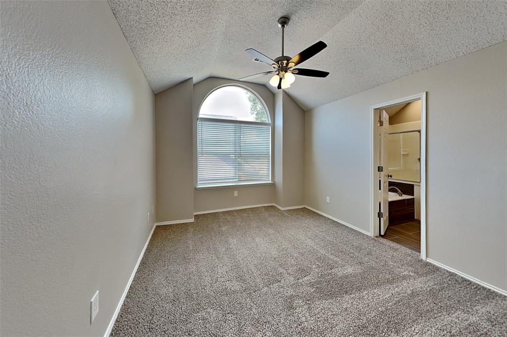 2301 Red Maple Road Flower Mound, TX 75022 - Photo 10 of 20 Unfurnished bedroom featuring light carpet, ceiling fan, lofted ceiling, a textured ceiling, and ensuite bathroom