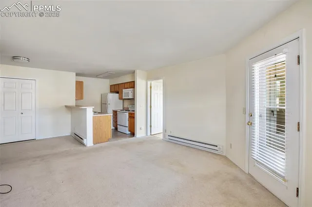 a view of a kitchen with wooden cabinet and a refrigerator