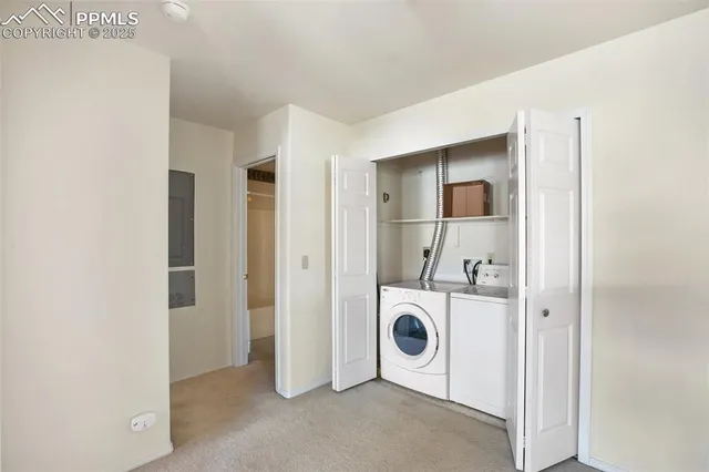 a view of a storage & utility room with dryer and washer