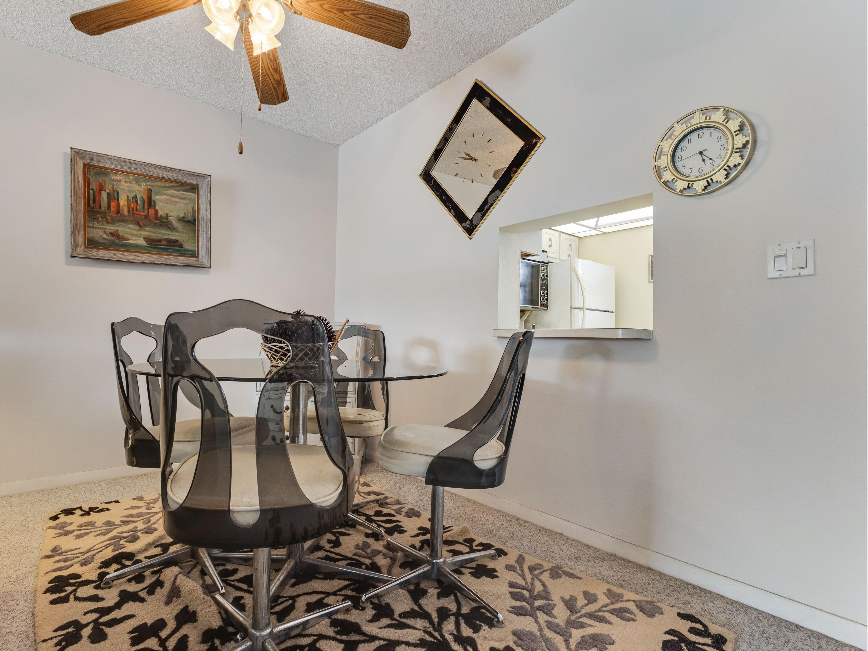 2615 Northeast 3rd Street, Unit 317 Boynton Beach, FL 33435 - Photo 8 of 41 a view of a dining room with furniture and wooden floor