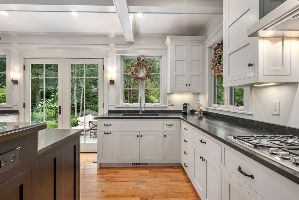 103 Conant Road Weston, MA 02493 - Photo 16 of 42 a large kitchen with stainless steel appliances granite countertop a sink stove and cabinets