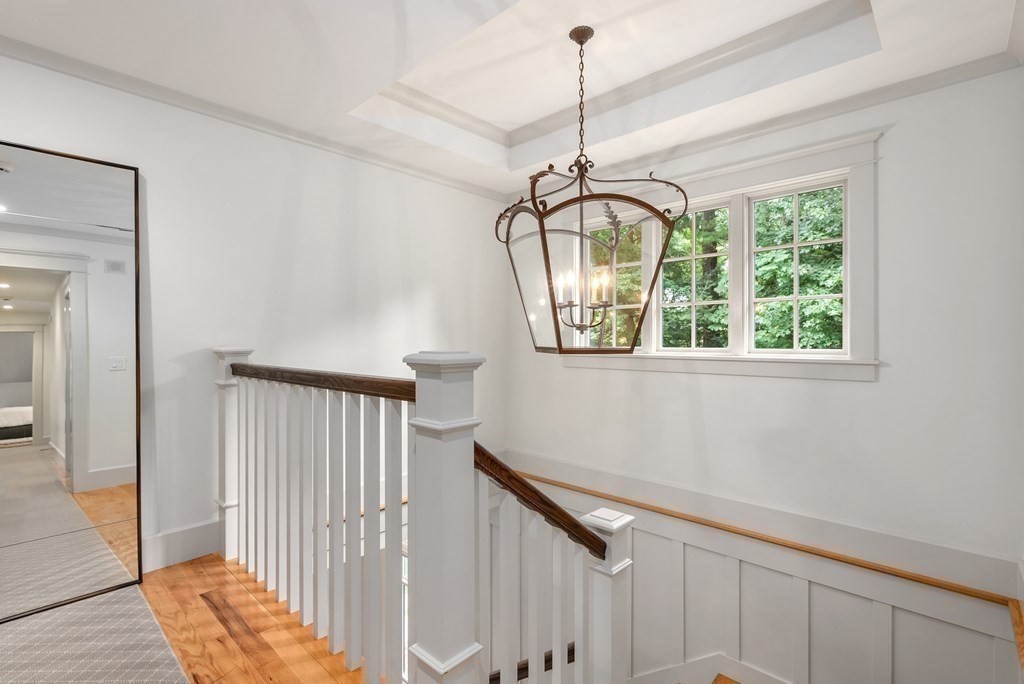 103 Conant Road Weston, MA 02493 - Photo 21 of 42 a view of a hallway with a chandelier