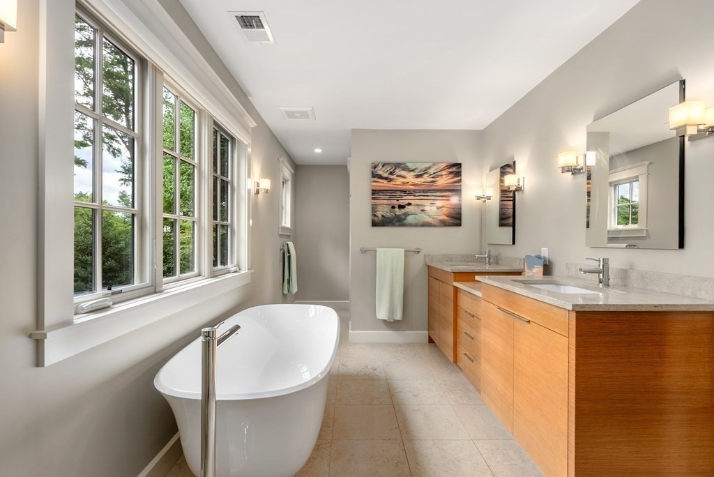 103 Conant Road Weston, MA 02493 - Photo 24 of 42 a spacious bathroom with a sink a bathtub and a large mirror
