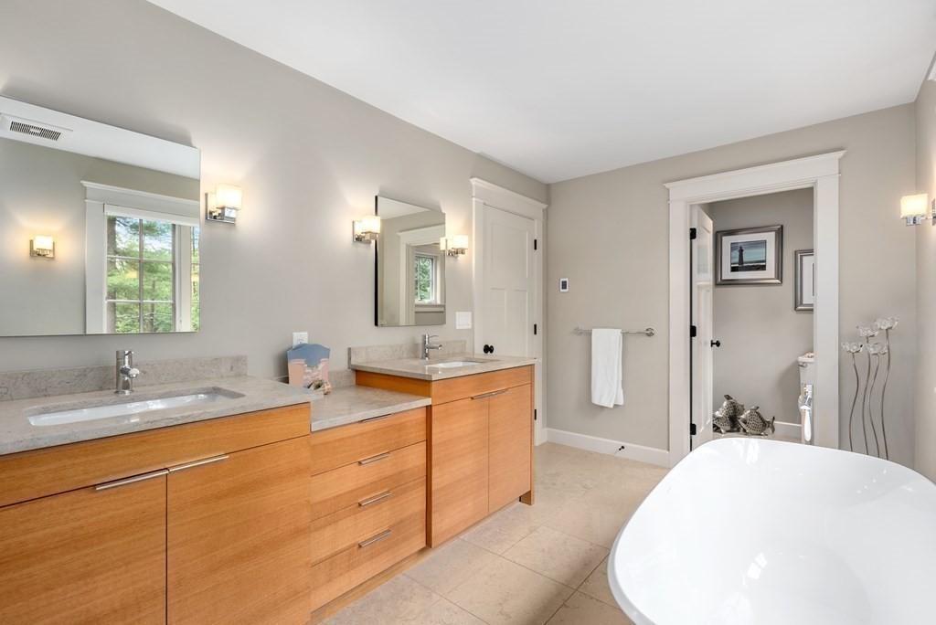103 Conant Road Weston, MA 02493 - Photo 25 of 42 a spacious bathroom with a sink a mirror and a bathtub