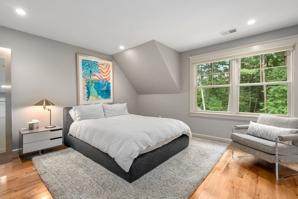 103 Conant Road Weston, MA 02493 - Photo 26 of 42 a bedroom with a bed a couch and a large window