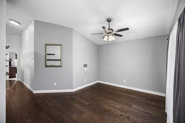 wooden floor in an empty room with a window