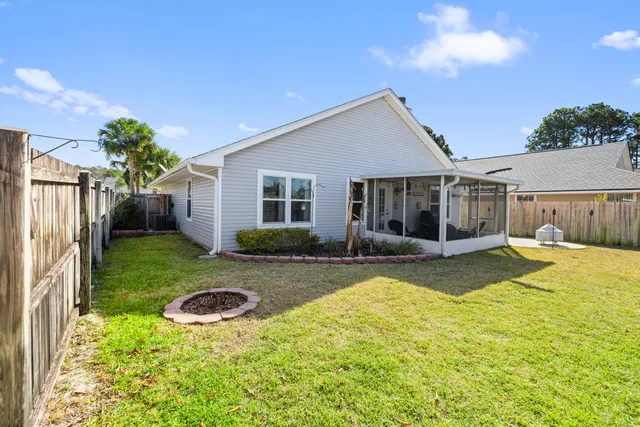 a en suite bathroom with a granite countertop double vanity sink a mirror and a shower