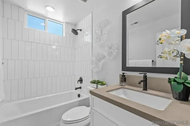 a bathroom with a sink a toilet and bathtub