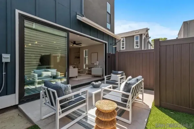 a view of a patio with table and chairs and potted plants