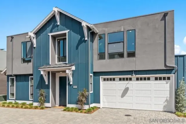 a front view of a house with garage
