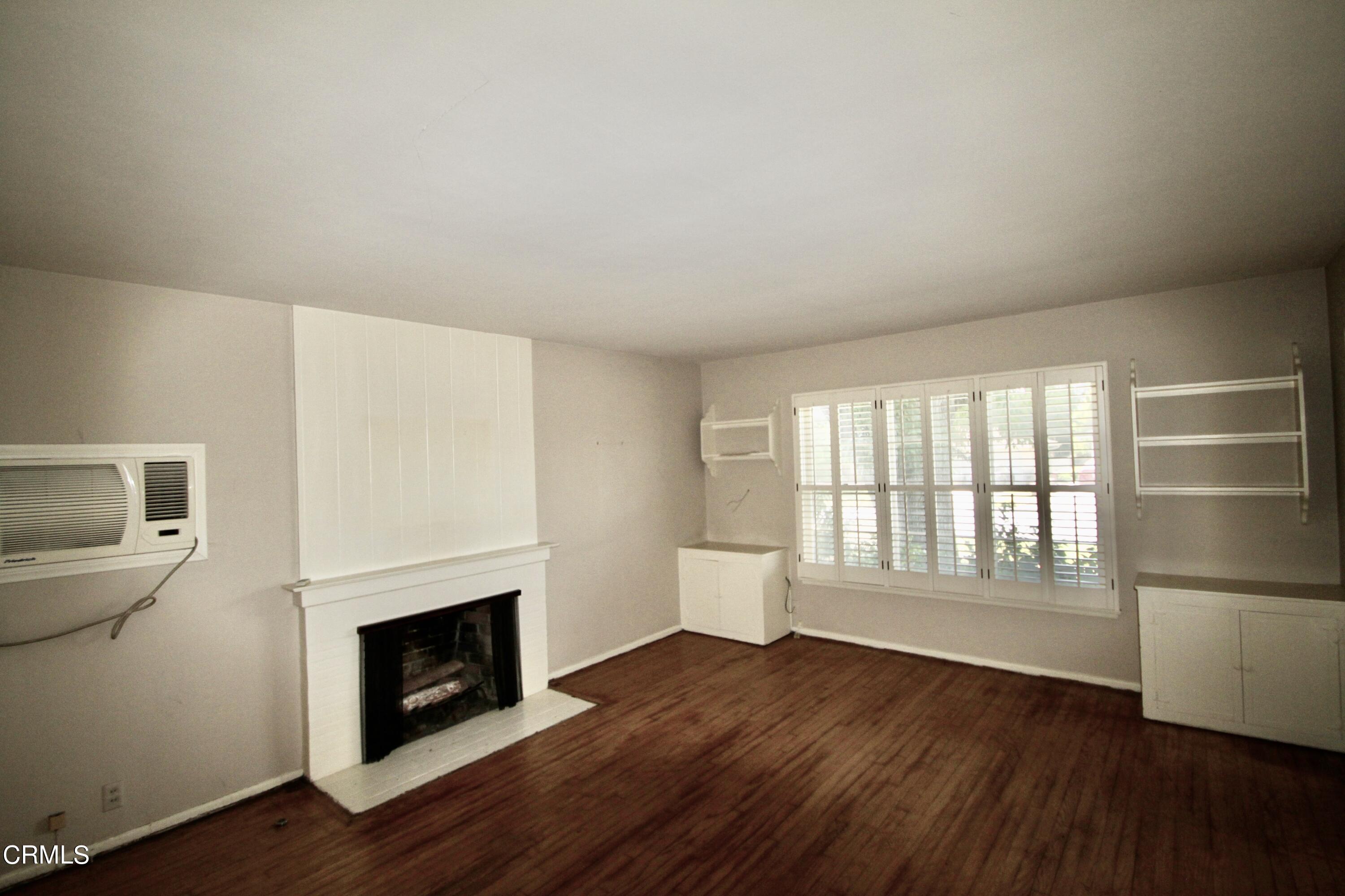 310 Santa Rosa Road Arcadia, CA 91007 - Photo 3 of 21 a view of an empty room with a fireplace and a window
