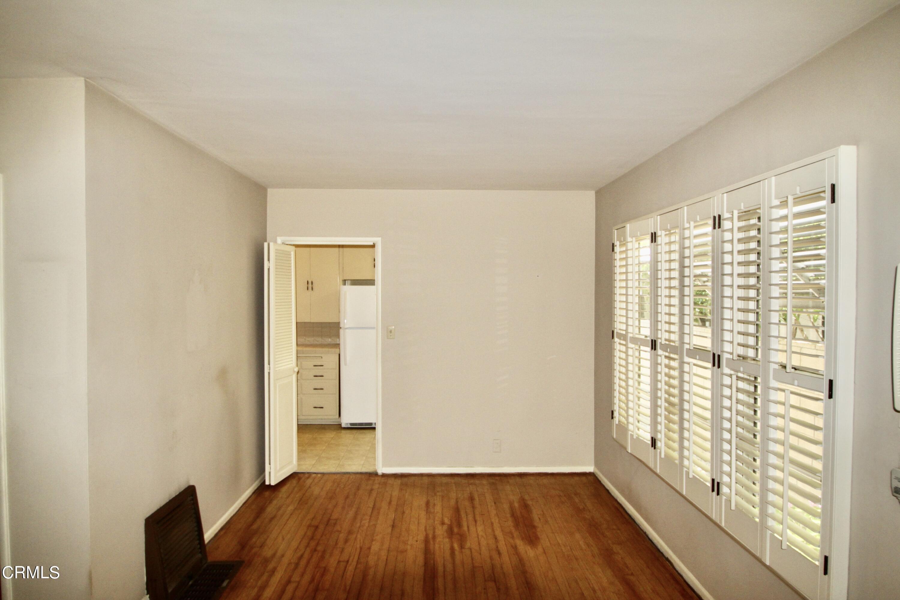 310 Santa Rosa Road Arcadia, CA 91007 - Photo 5 of 21 a view of an empty room with glass door and wooden floor