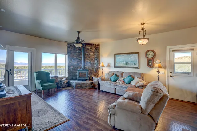 a living room with furniture a fireplace and a chandelier