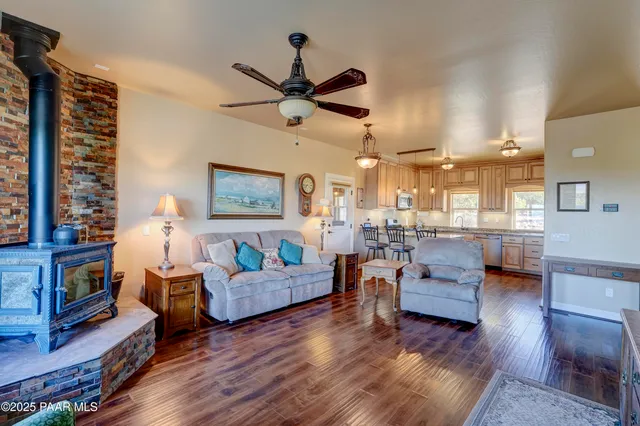 a living room with fireplace furniture and a wooden floor