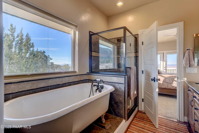 a bathroom with a bathtub and a shower