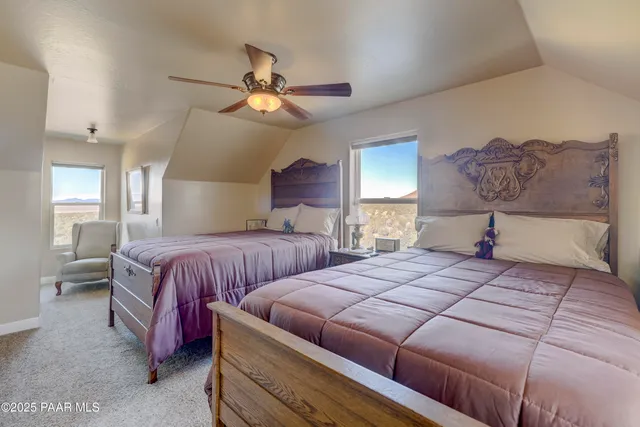 a bedroom with bed and a chandelier