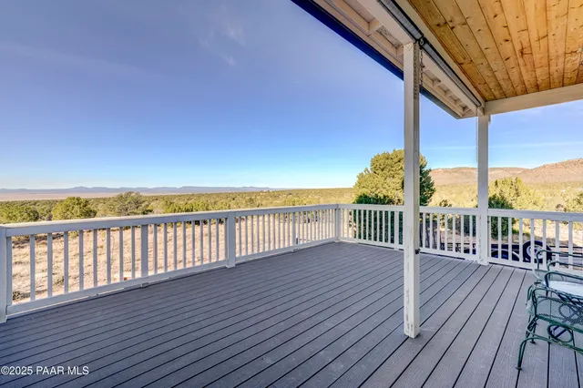 a view of balcony with wooden floor and seating space