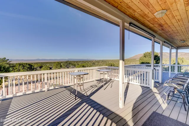 a view of balcony with wooden floor and seating space