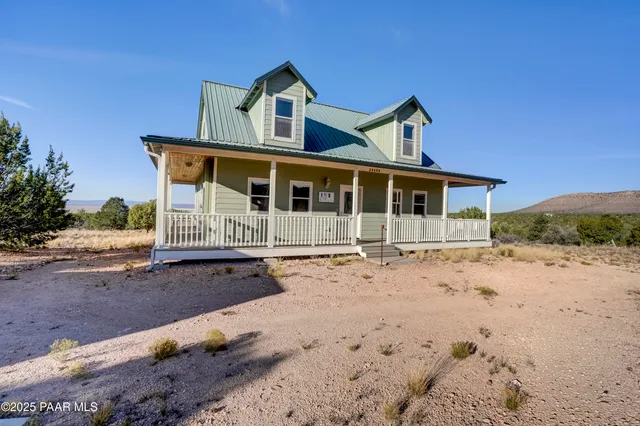 front view of a house with a dirt yard