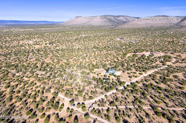 a view of a dry yard and mountains
