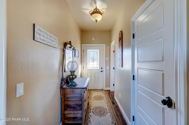 a view of hallway with wooden floor