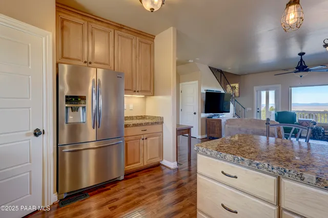 a kitchen with granite countertop a refrigerator and a sink