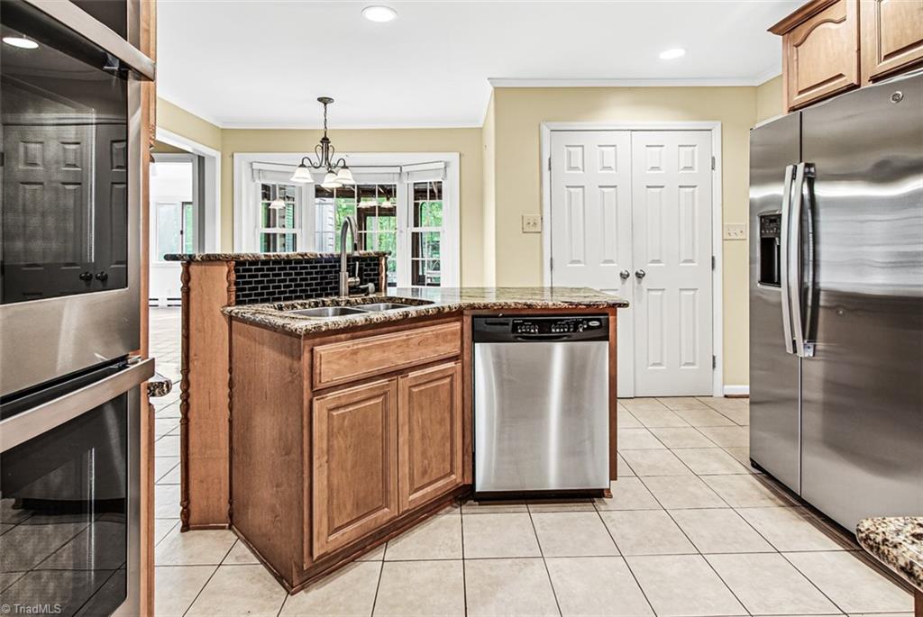 3903 Oakcliffe Road Greensboro, NC 27406 - Photo 12 of 42 Kitchen offers double ovens and stainless appliances.