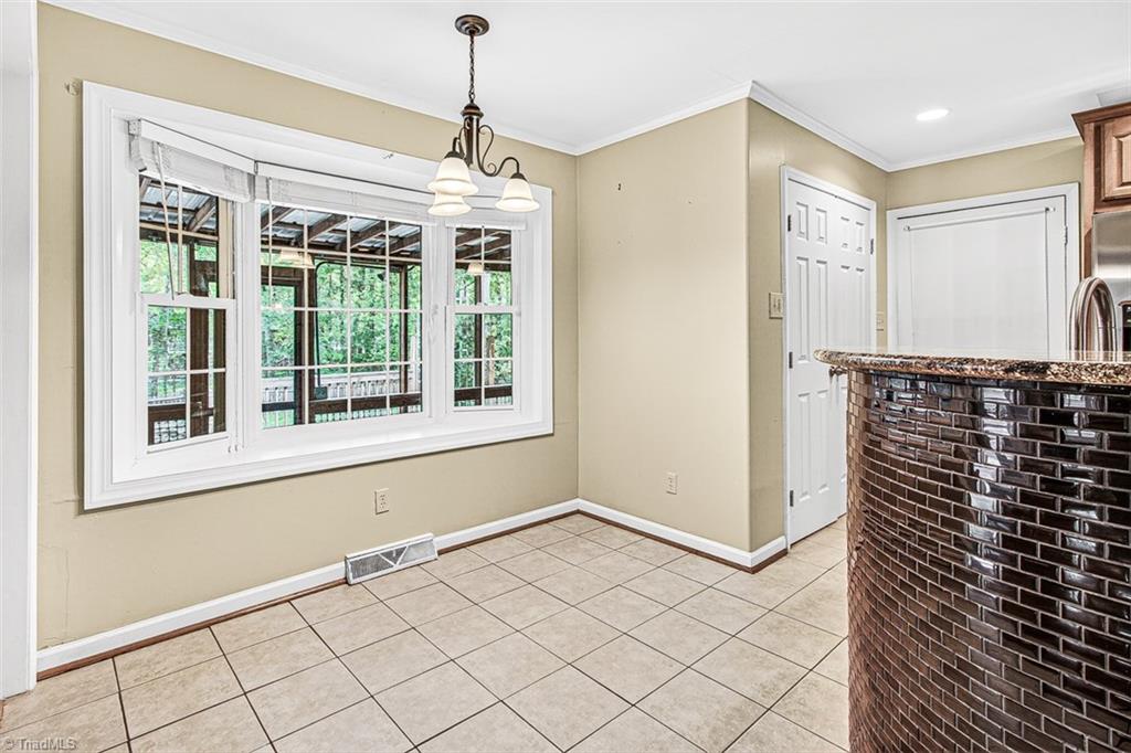 3903 Oakcliffe Road Greensboro, NC 27406 - Photo 15 of 42 Breakfast area overlooks the screen porch.
