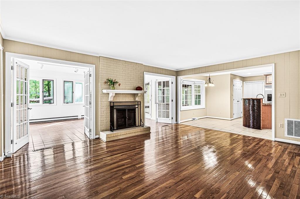 3903 Oakcliffe Road Greensboro, NC 27406 - Photo 16 of 42 Den opens to the sunroom with dual french door.
