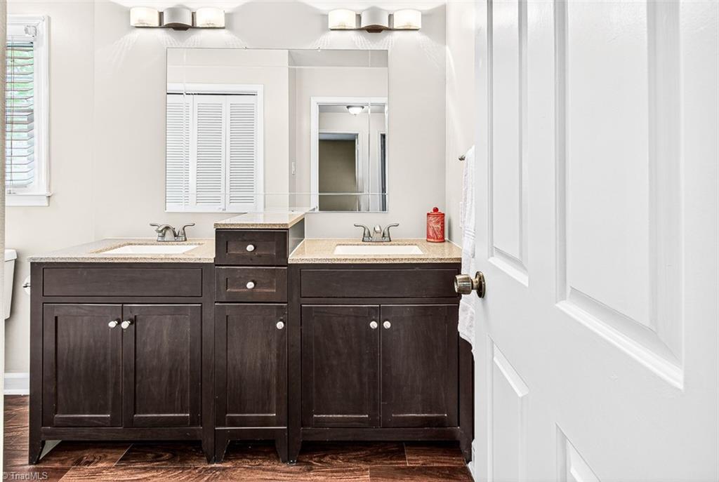 3903 Oakcliffe Road Greensboro, NC 27406 - Photo 32 of 42 Upper hall bath with dual sinks and solid surface top.