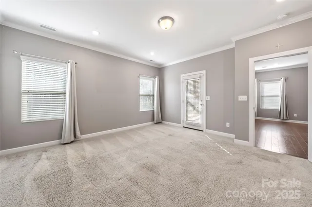 an empty room with windows and closet