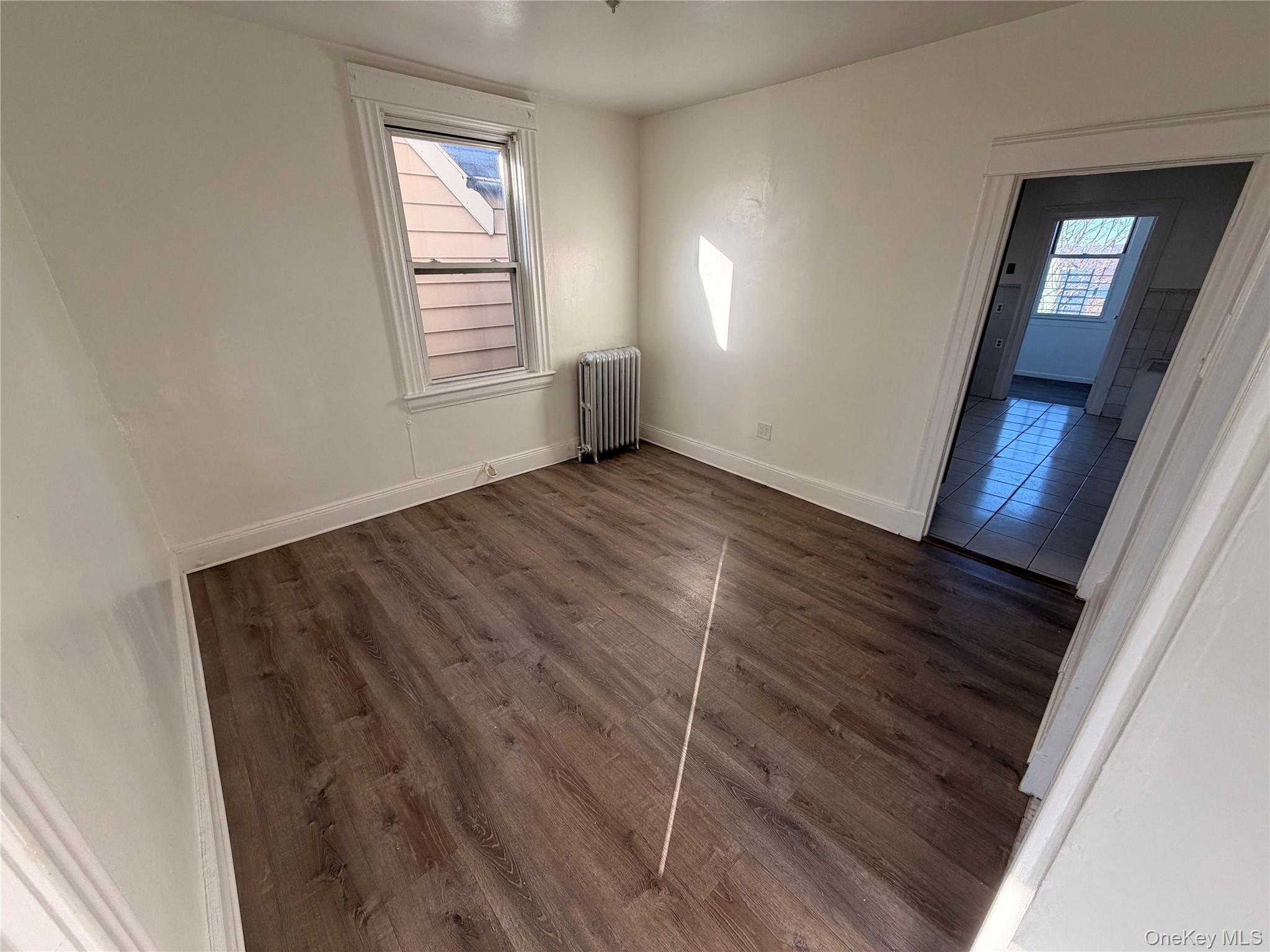 13 Cedar Street, Unit 3 Yonkers, NY 10701 - Photo 11 of 12 a view of an empty room with wooden floor and a window