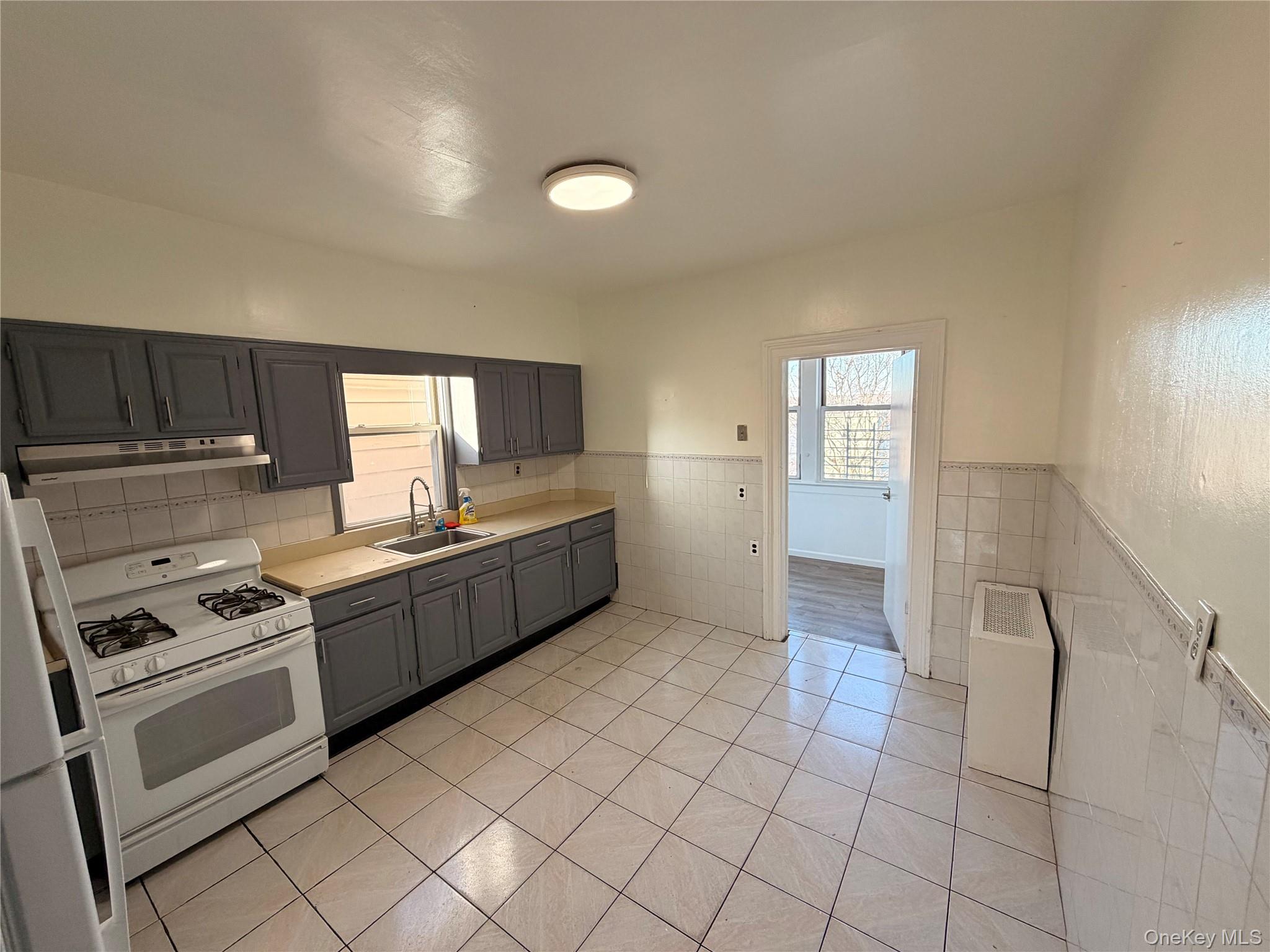 13 Cedar Street, Unit 3 Yonkers, NY 10701 - Photo 8 of 12 a kitchen with stainless steel appliances granite countertop a stove a sink and a refrigerator