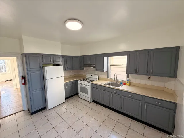 a kitchen with a sink cabinets and window