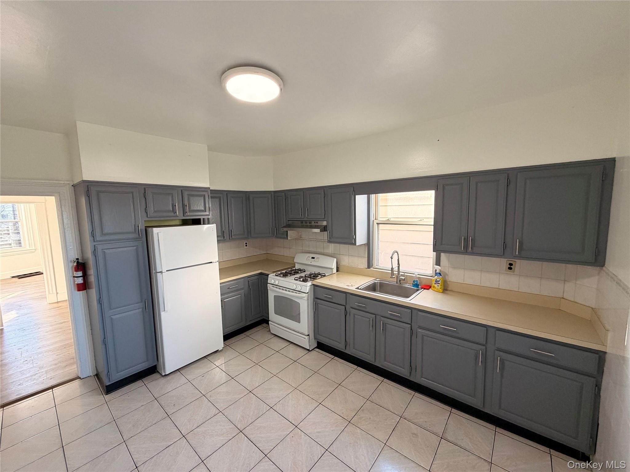 13 Cedar Street, Unit 3 Yonkers, NY 10701 - Photo 9 of 12 a kitchen with a sink cabinets and window