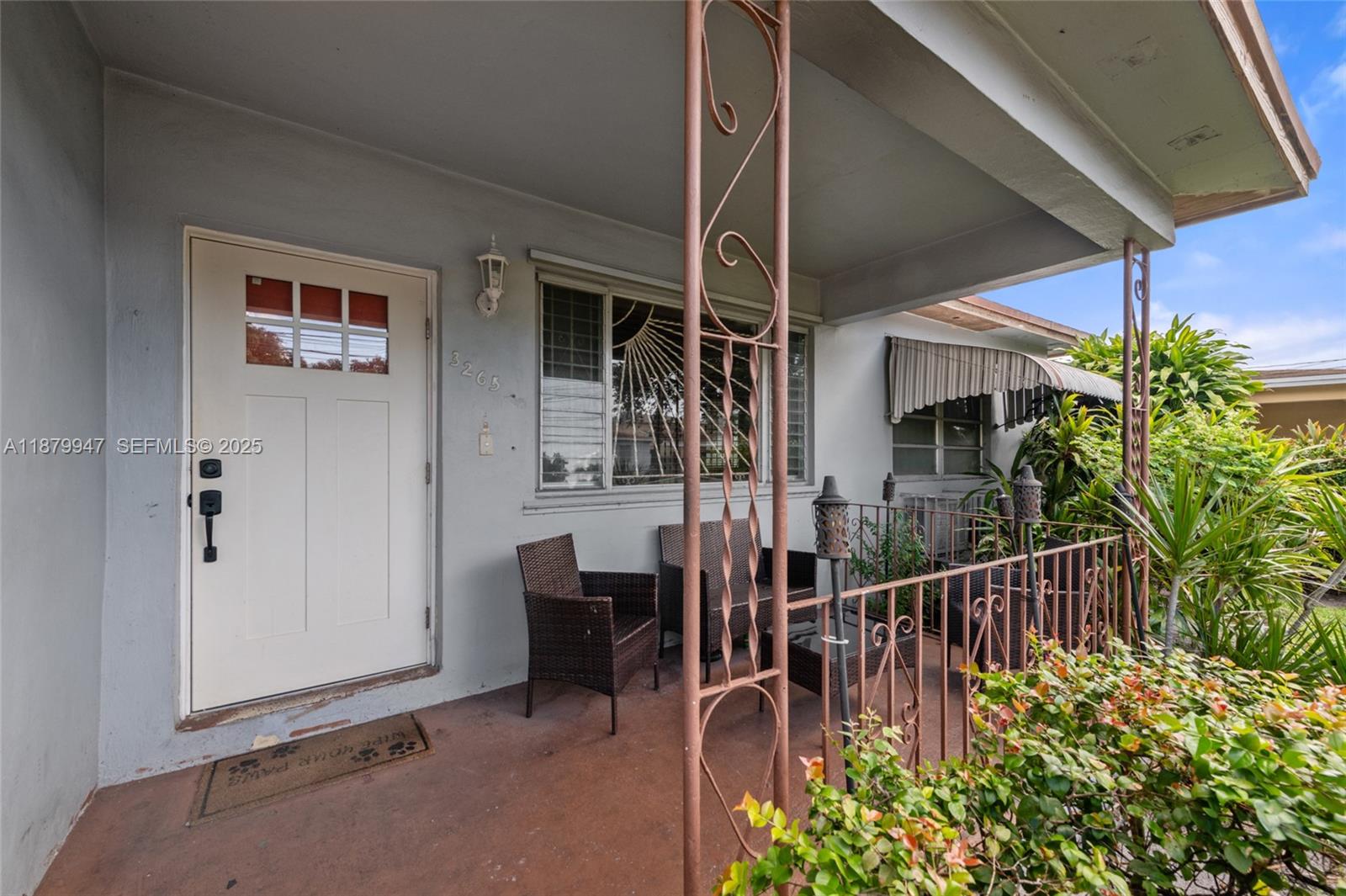 3265 Northwest 50th Street Miami, FL 33142 - Photo 3 of 17 a view of balcony with two chairs and a potted plant