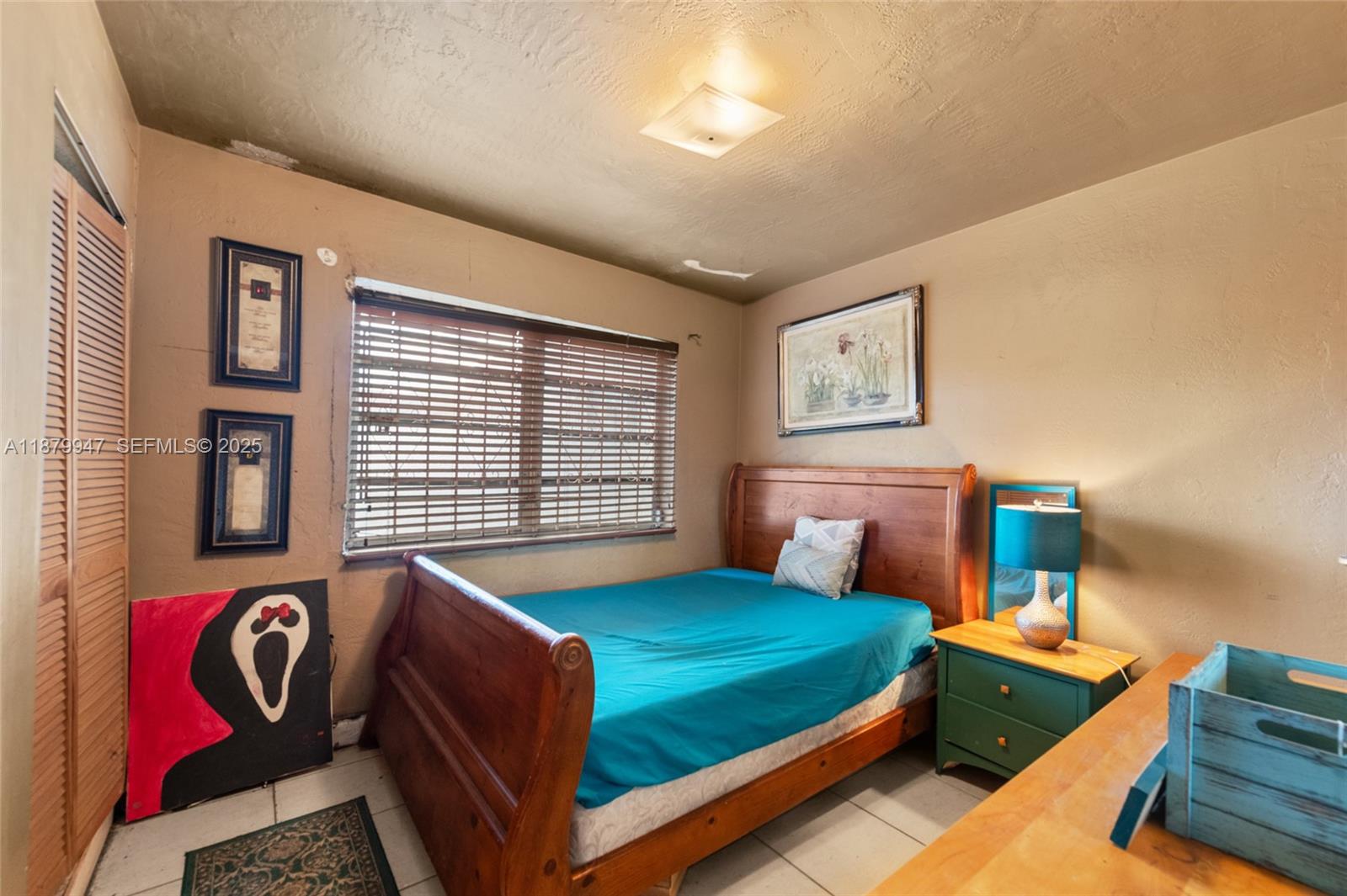 3265 Northwest 50th Street Miami, FL 33142 - Photo 9 of 17 a bedroom with 2 bed and a window