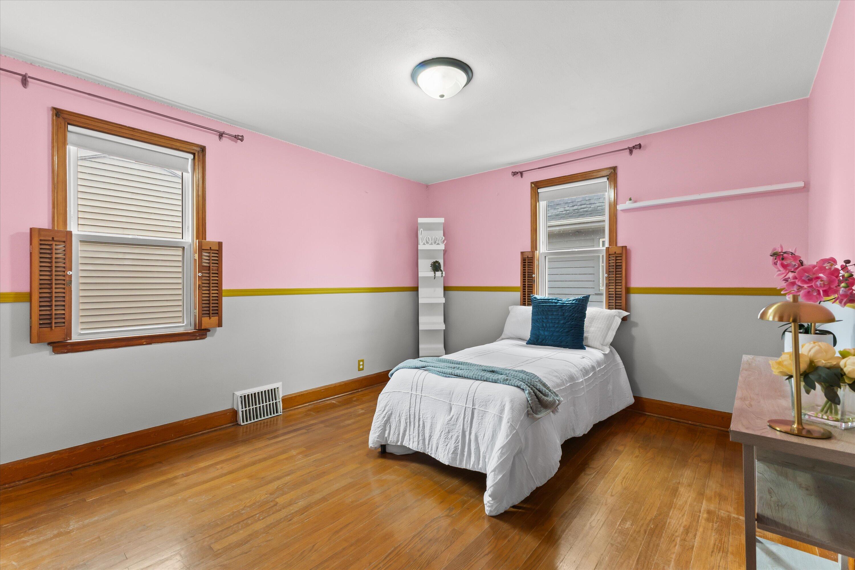 2925 North Main Street Racine, WI 53402 - Photo 13 of 23 A bright, cheerful bedroom with hardwood flooring, ample closet space, and flexibility for guests, children, or a home office.