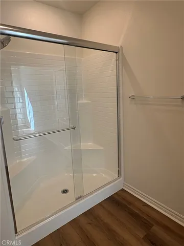 a bathroom with a glass shower door