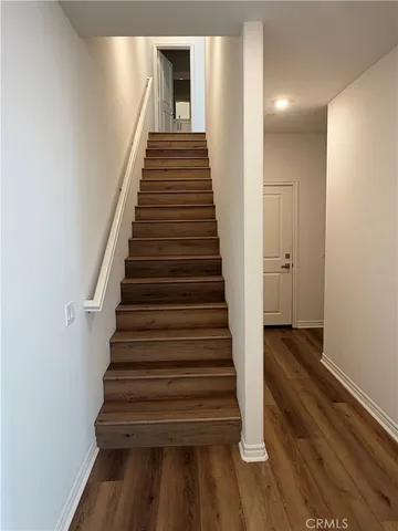 a view of entryway and hall with wooden floor