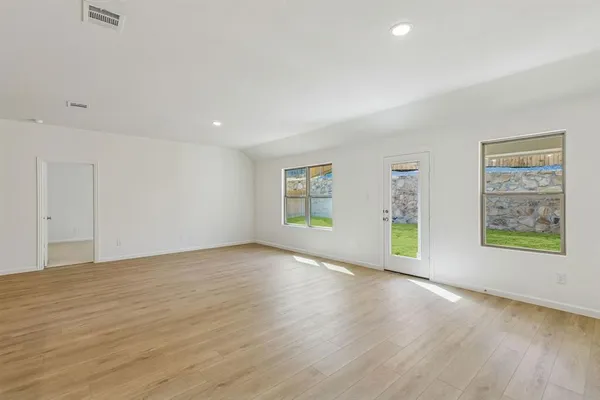wooden floor in an empty room with a window