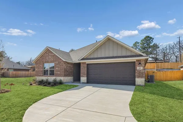 a front view of house with yard garage and green space