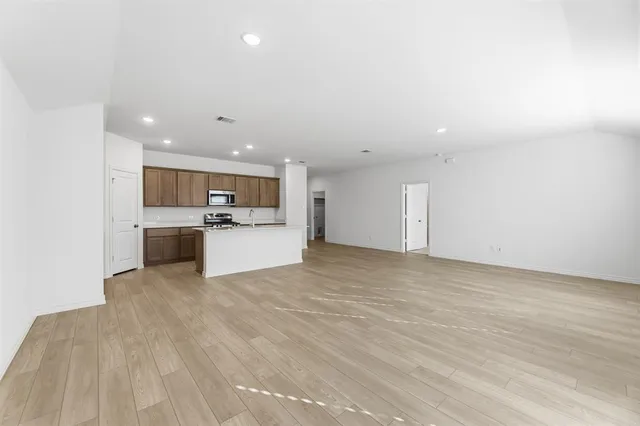 a view of a kitchen with a sink and a refrigerator