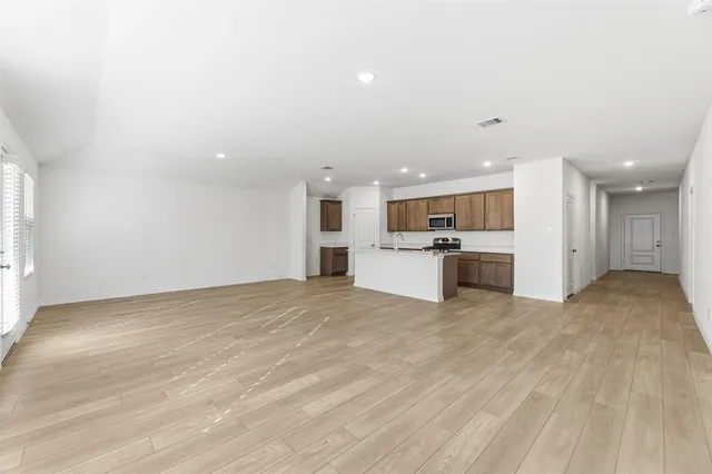 a view of kitchen with white cabinets and refrigerator
