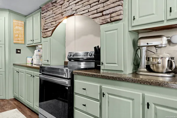 a kitchen with stainless steel appliances granite countertop a sink and cabinets