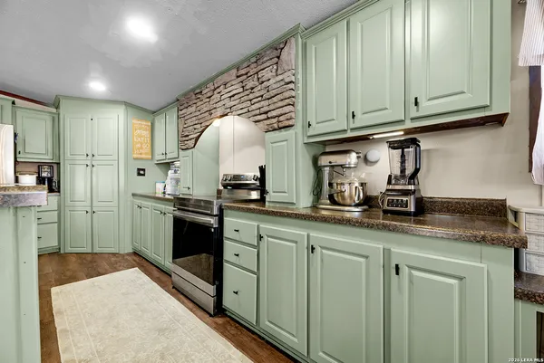 a kitchen with stainless steel appliances granite countertop a sink and cabinets