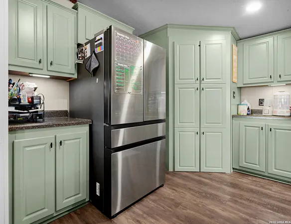a kitchen with a refrigerator and cabinets